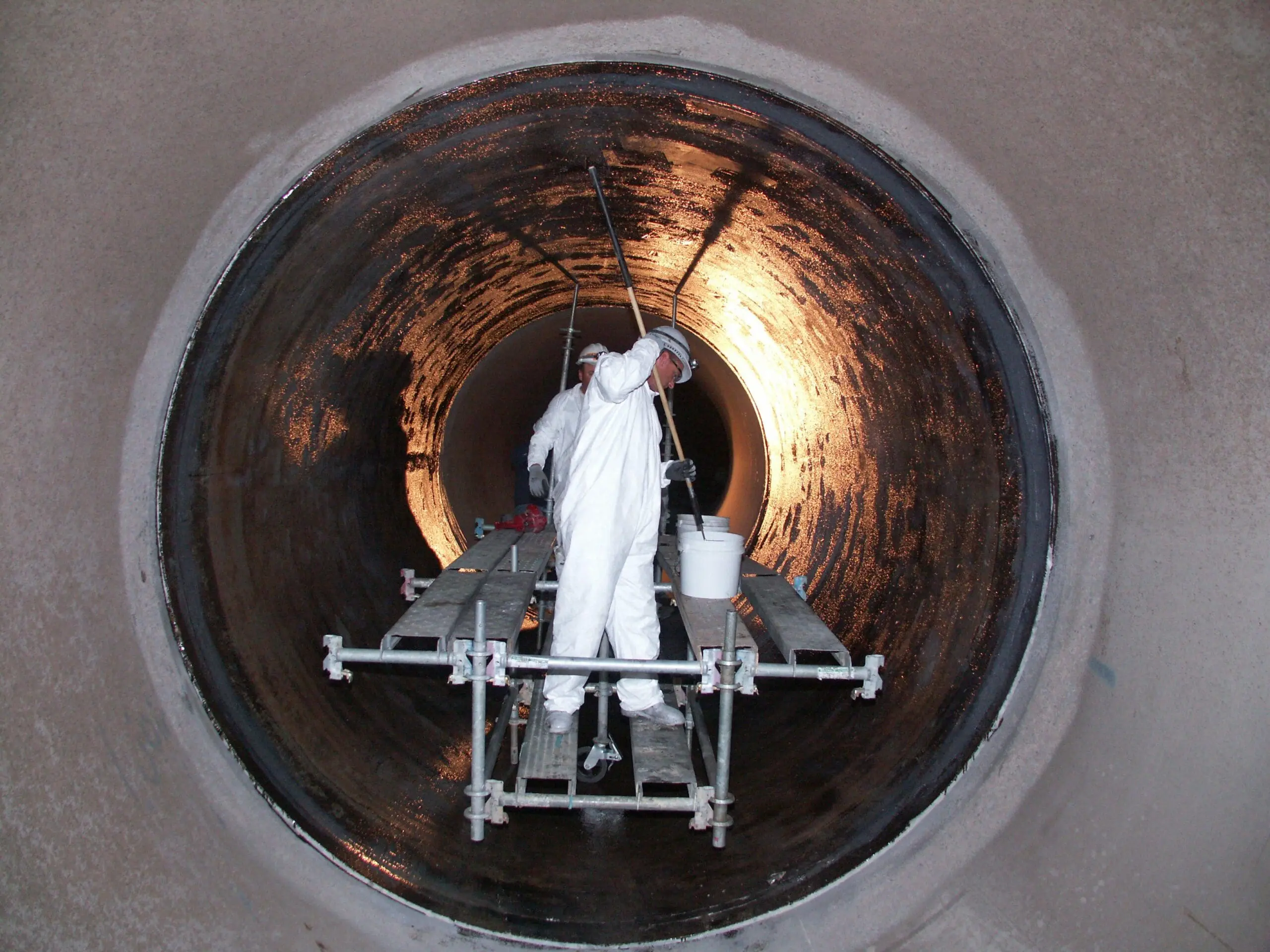 Painters in large pipe